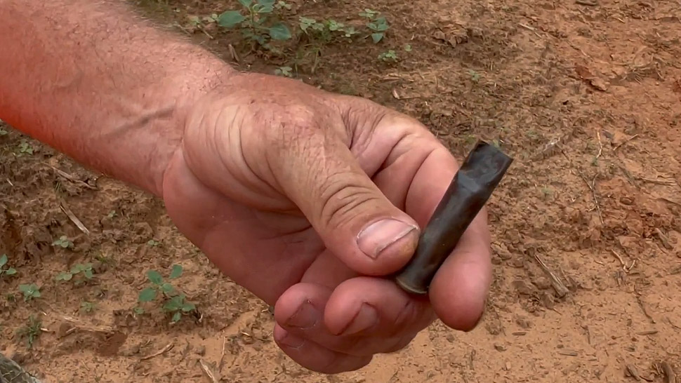 A Man Holds the Empty 9mm Caliber Casing