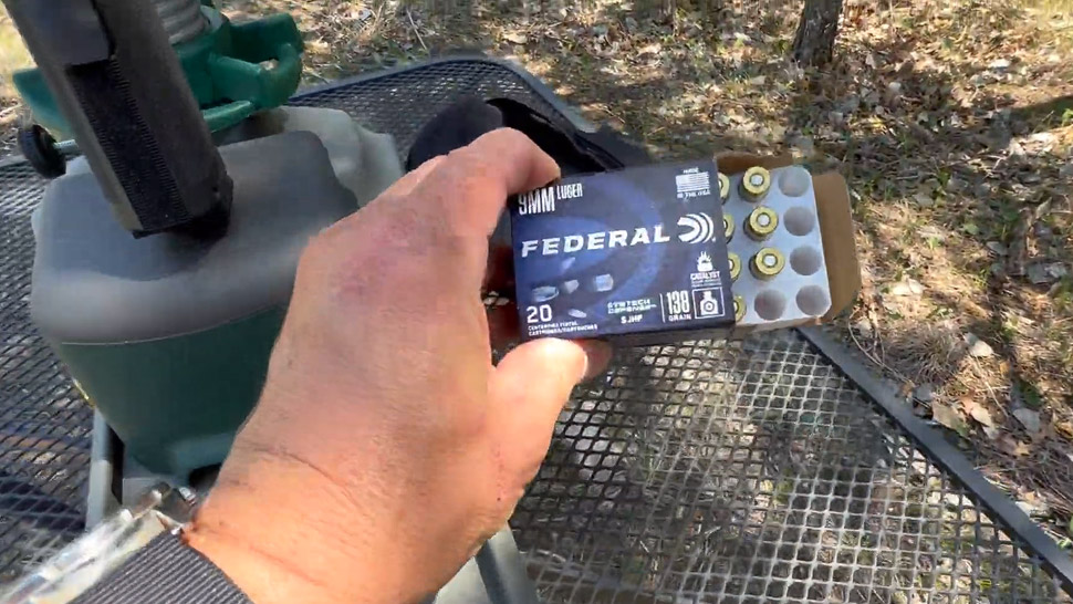 A Man Is Showing a Box of Federal Syntech Defense 9mm Ammo