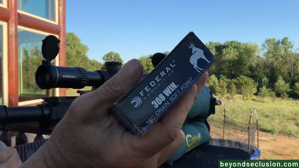 A Man Is Showing a Box of Federal 308 Winchester Hunting Ammo - 180 Grain Soft Point
