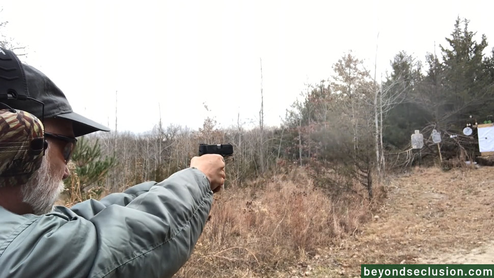 A Man is Shooting With a Gun at the Range