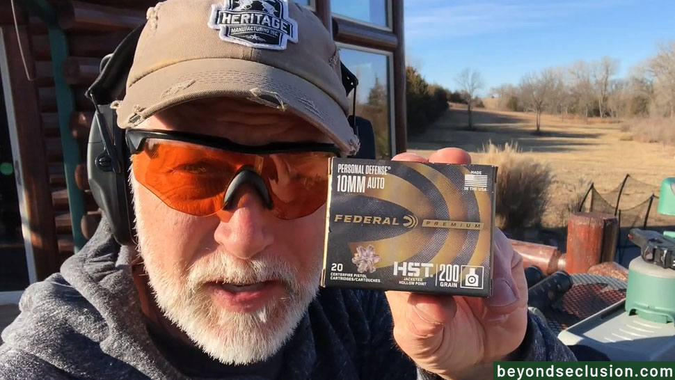 A Man Is Holding the Box of Federal 10 Ammo HST Premium